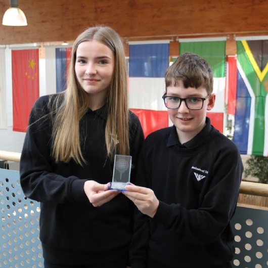 two students with their golfing trophy